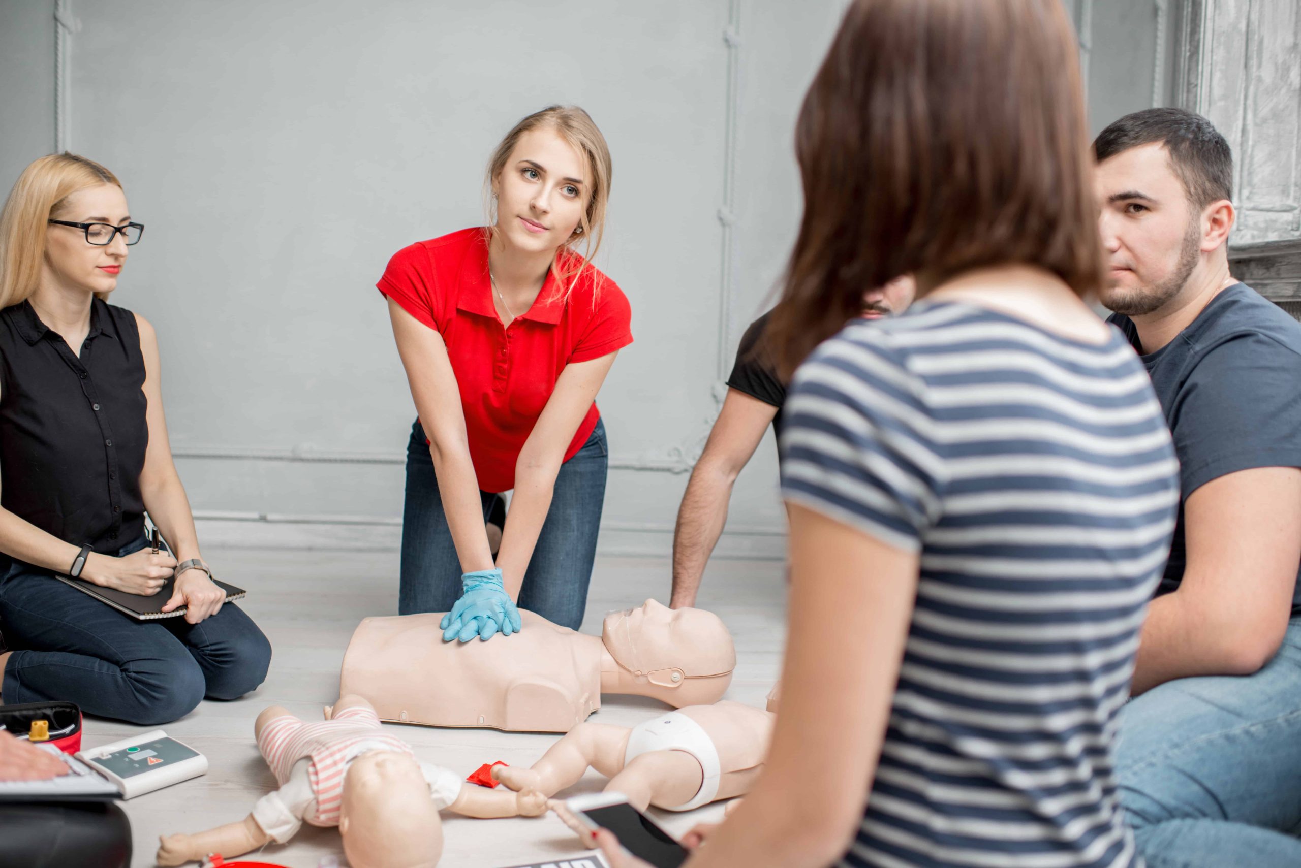 Instructor demonstrating proper chest compressions during BLS certification class