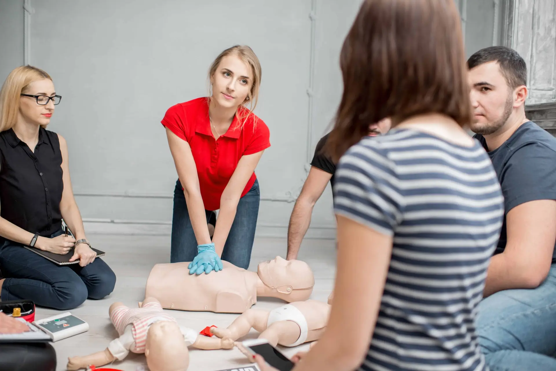 Instructor demonstrating proper chest compressions during BLS certification class