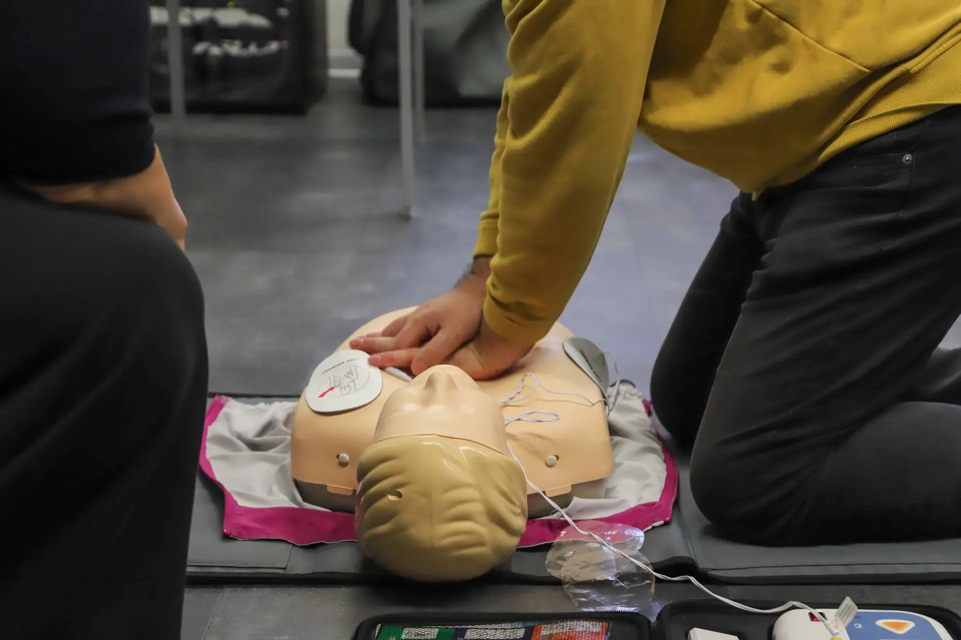 Participant performing high quality chest compressions during BLS skills assessment